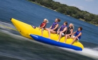 girls on yellow tube on lake