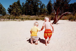 Toddlers walking in sand at Norfork Lake