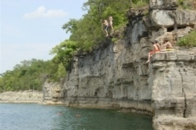 Boys jump from bluff at lake