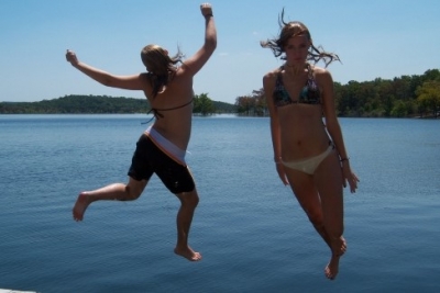 Girls jump into Nofork Lake