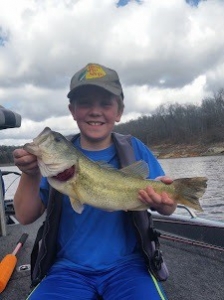 Boy with bass fish on Norfork Lake