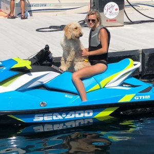 Girl and dog on jet ski