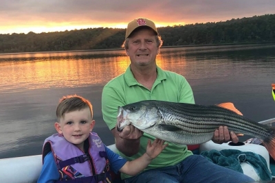 Father and son with Norfork Lake striper