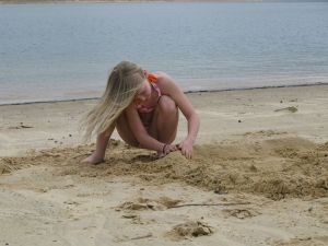 Girl playing in sand at Norfork Lake