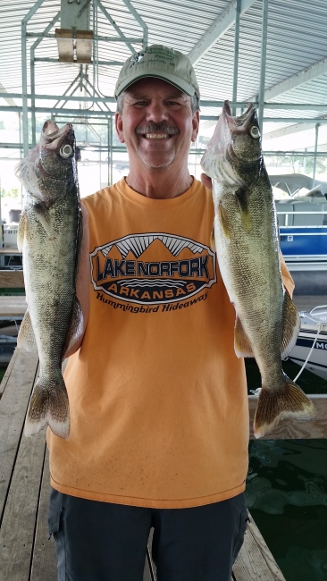 Man with two walleye fish