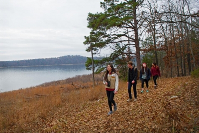 Family hiking along Norfork Lake shore