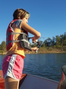 Girl fishing from boat on Norfork Lake