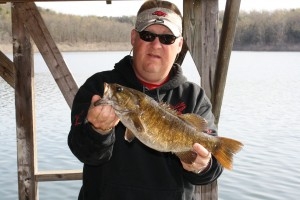 Fisherman with Bass fish on Norfork Lake