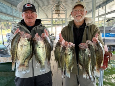 Two fishermen with lots of crappie fish